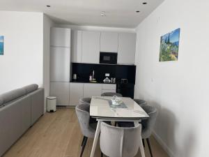 a living room with a white table and chairs at Jadran Dream in Rafailovici