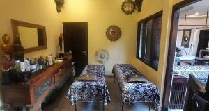 a room with two beds and a table in it at Rambutan Hotel in Lovina