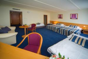 Postel nebo postele na pokoji v ubytování TOP HOTEL Praha