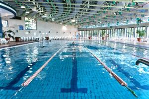 a large swimming pool with blue water at Kfar Giladi Hotel in Kefar Gil‘adi +99 photos