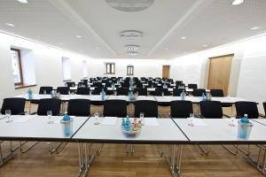 a large room with tables and chairs in it at Boardinghouse My Maison in Morschen