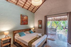 Un pat sau paturi într-o cameră la Pousada Villa Zen