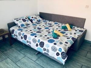 a bed with a blue and white comforter and pillows at Lovely studio apartment Mare e Sole in Labin