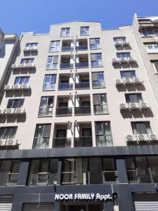 a building with a sign on the front of it at NOOR FAMILY APARTMENTS in Bursa