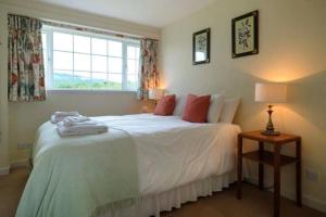 a bedroom with a bed and a window at Garbity Cottage in Fochabers