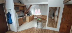 una pequeña cocina con armarios de madera y una mesa. en Apartament Gliwice Centrum en Gliwice