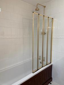 a bathroom with a shower and a white tub at The Lagg in Lagg