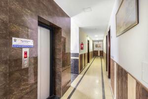 a hallway of a hospital with a sign on the wall at FabHotel Jindal Palace in New Delhi