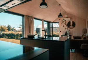 a kitchen with a black counter and a large window at Tiny house XXL in Bant