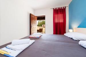 a bedroom with a bed and a red curtain at Secret Rooms in Rovinj