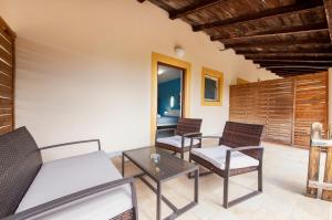 a living room with chairs and a couch and a table at Secret Rooms in Rovinj