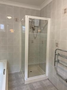 a shower with a glass door in a bathroom at The Lagg in Lagg