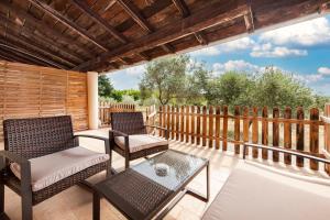 a patio with two chairs and a table on a deck at Secret Rooms in Rovinj