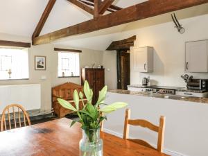 a kitchen and dining room with a table and chairs at Yr Hen Dy in Colwyn Bay +29 photos