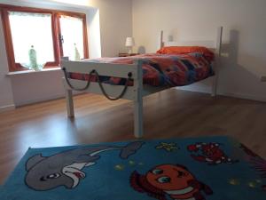 a bedroom with a bed and a rug at B&B L'Ortensia in Vignolo