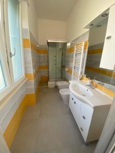 a bathroom with two sinks and a shower and a toilet at Melody Rooms in Soverato Marina