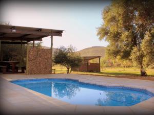 a swimming pool in the middle of a yard at Lylius Cottage and Campsites in Clanwilliam