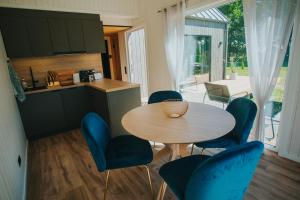 a kitchen and dining room with a table and chairs at Goba Sauleskempings in Mērsrags