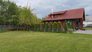 a house with a yard in front of it at Cabana Rustic Bran in Bran