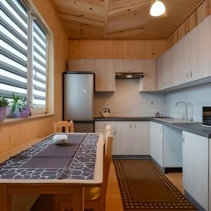 a kitchen with a table and a refrigerator at uMarcina in Jurgów +19 photos