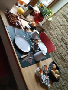 una mesa de madera con comida encima en chambres d'hôtes Le Carillon en Bergues