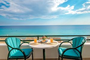 a table and chairs with a view of the ocean at Glyfada New Era Home 107 Menigos Resort Apartments in Glyfada