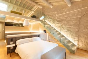 a bedroom with a bed and a staircase at Scaravelli Residenza in Mantova