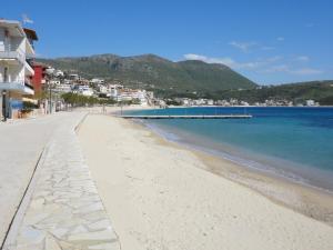 a view of a beach with buildings and the ocean at Spiro Guest House in Himare
