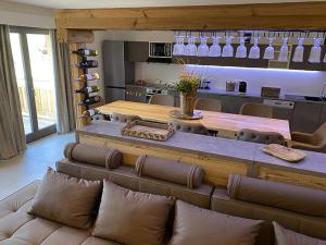 a living room with a table and a couch at Les Trois Chaufatons - Chalets Boutiques in Montriond