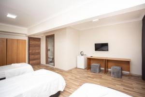 A television and/or entertainment centre at Türkler Suite Hotel
