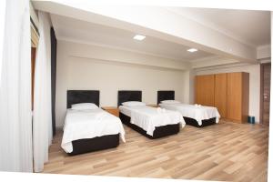 A bed or beds in a room at Türkler Suite Hotel