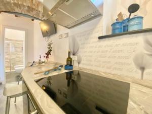 a kitchen with a sink and a bottle of wine at CasaViva - Trilo on the heights of S Margherita in San Lorenzo della Costa