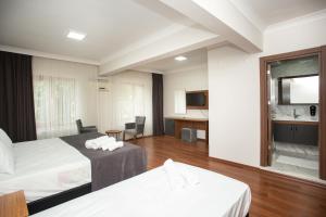 A bed or beds in a room at Türkler Suite Hotel