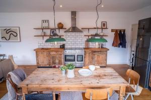a kitchen with a wooden table in a kitchen at Penthouse at The Old Tea Factory in London