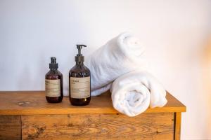 two bottles of wine and a towel on a wooden table at Penthouse at The Old Tea Factory in London