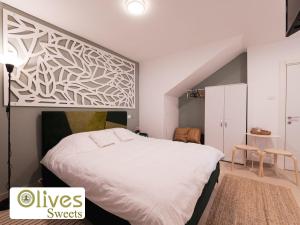 a bedroom with a large white bed in a room at Olives sweets in Arad