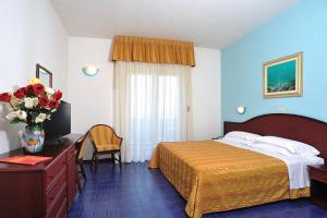 Postel nebo postele na pokoji v ubytování Hotel Vittoria - Nuova Gestione