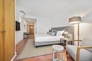 a living room with a couch and a table at The Patio Suite Hotel in Albufeira