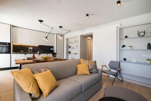 a living room with a couch and a kitchen at Sea View apartment Maja in Bol