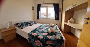 a small bedroom with a bed and a window at Villa Vesna in Preko