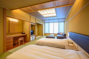 Uma cama ou camas num quarto em Oishiya