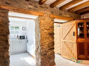 a barn door in the kitchen of a house at Hafan Hedd Cottage in Solva