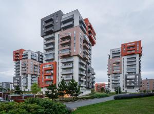 two tall apartment buildings in a city at Penthouse Letňanské zahrady in Prague