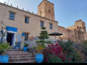a building with a bunch of plants in front of it at Escale Rando Taliouine in Taliouine