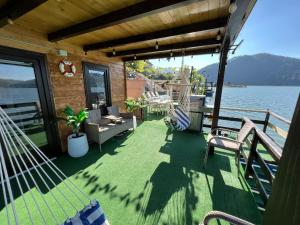 a porch of a house with a view of the water at Holiday Bicaz Bungalows On The Lake in Bicaz
