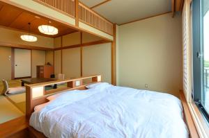 Uma cama ou camas num quarto em Oishiya
