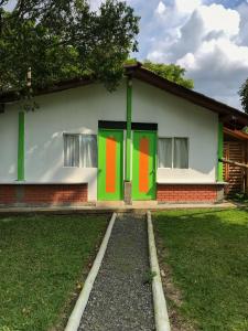 a house with green and red doors on it at Room in Guest room - Room with 2 double beds - Number 14 in Rizaralda
