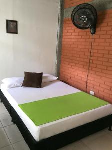a bed in a room with a green blanket on it at Room in Guest room - Room with 2 double beds - Number 14 in Rizaralda