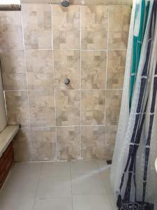 a shower in a bathroom with a shower curtain at Room in Guest room - Room with 2 double beds - Number 14 in Rizaralda