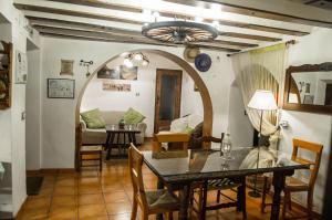 a living room with a table and a dining room at Casa Cueva Alegría in Valdeganga